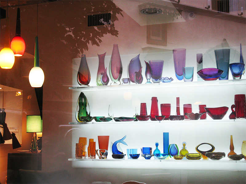 Street store located in Rome, Italy. Near it's window it is displaying multicolored glass blown items like vases, bowls, cups etc.