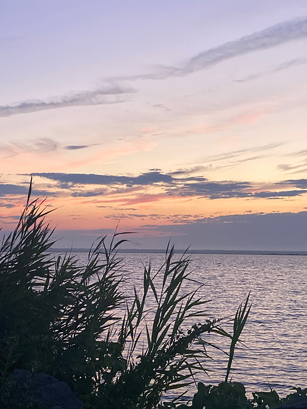 Purple, pink color mix sky of a sunset over the bay at Harvey Cedars, New Jersey.